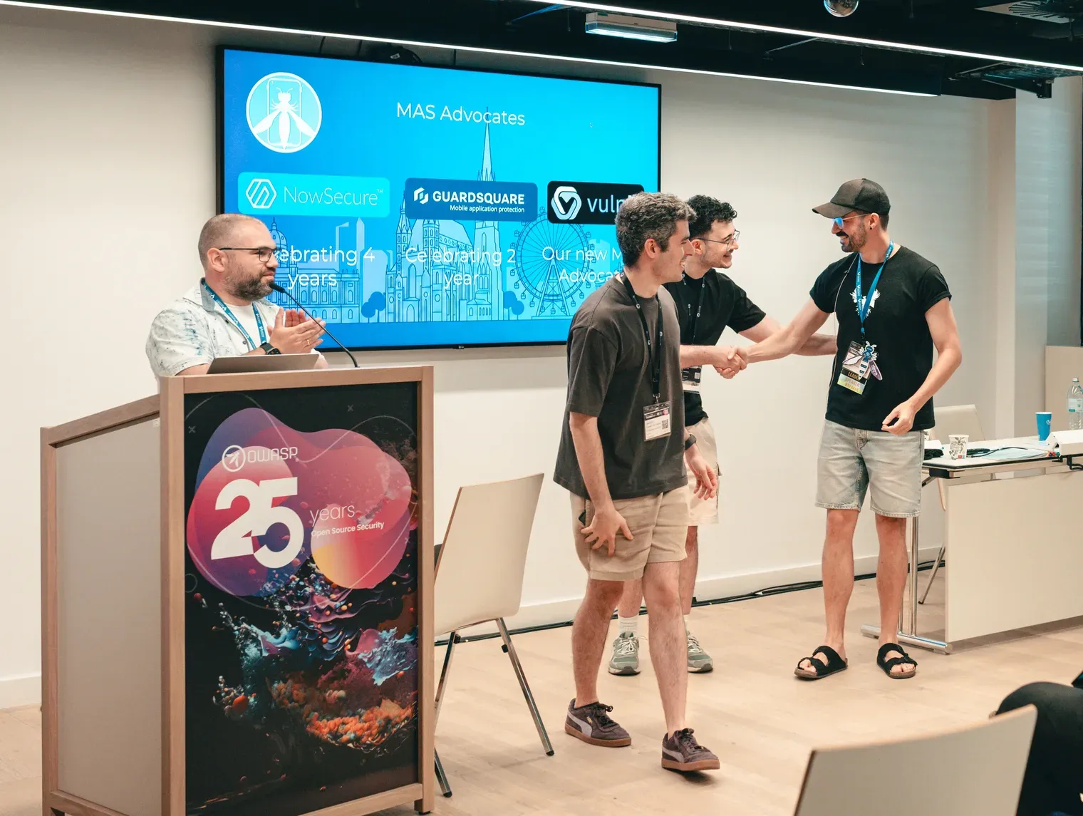 Group at MAScon during the OWASP MAS Advocate recognition, with vulnit on the presentation screen.
